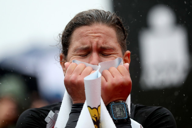 Emma Bilham of Switzerland becomes emotional after crossing the line in first place in the women's category
