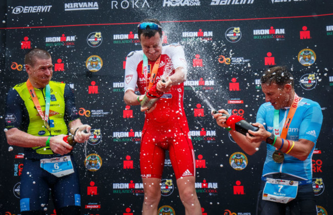 Bryan McCrystal, Alistair Brownlee and Markus Thomschke spray champagne on the podium