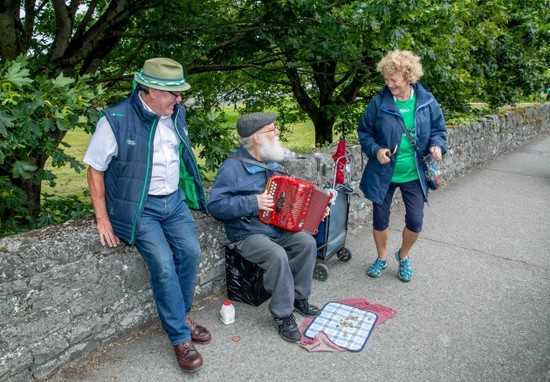 Seamus and Nora Kennedy do a jig alongside a local musician