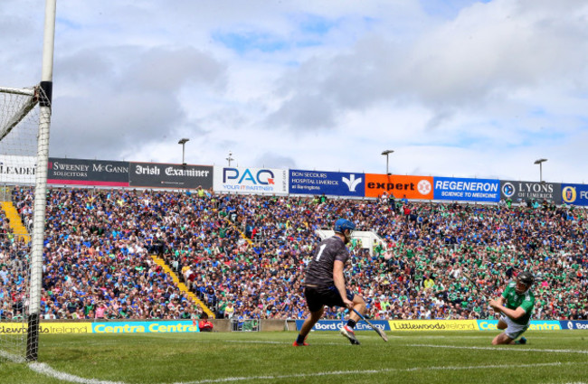 Peter Casey scores his sides opening goal past goalkeeper Brian Hogan