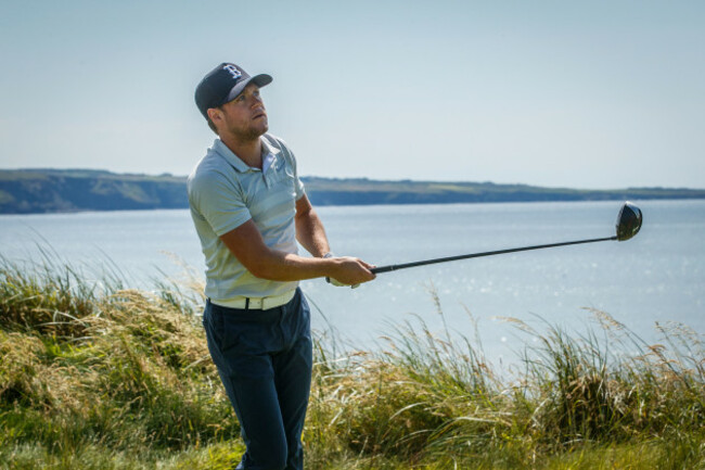 Niall Horan hits his tee shot on the 7th
