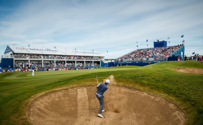 Padraig Harrington hits out of the bunker on the 18th hole in front of the Grand Stand