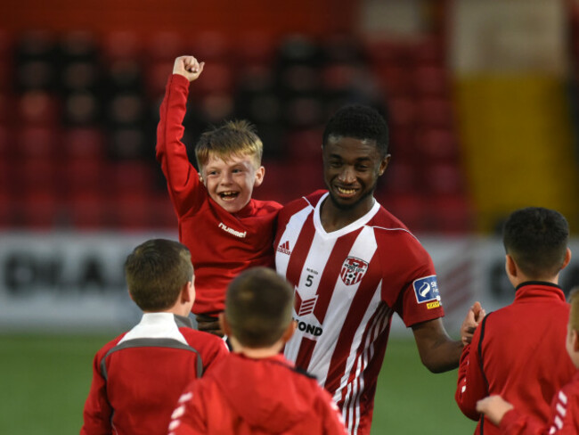 Junior Ogedi Uzokwe celebrates with a young fan at full time