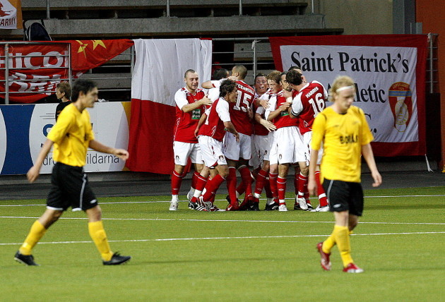 Gary Dempsey is mobbed by teammates after scoring