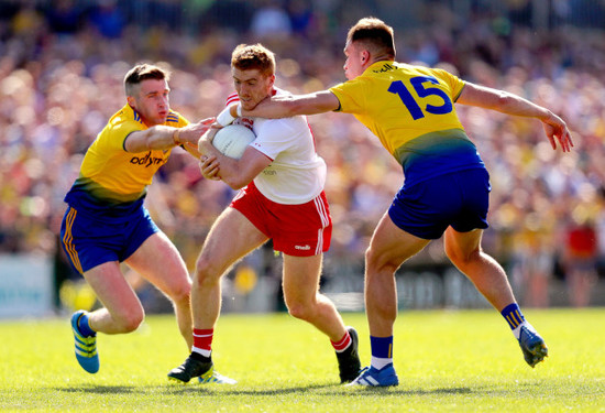 Kyle Coney is tackled by Cathal Cregg and Enda Smith