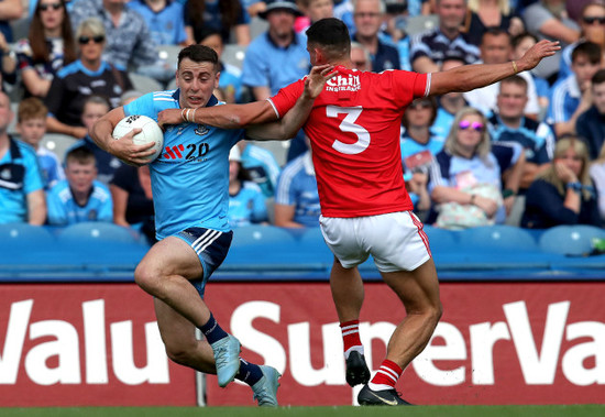 Cormac Costello is tackled by Thomas Clancy