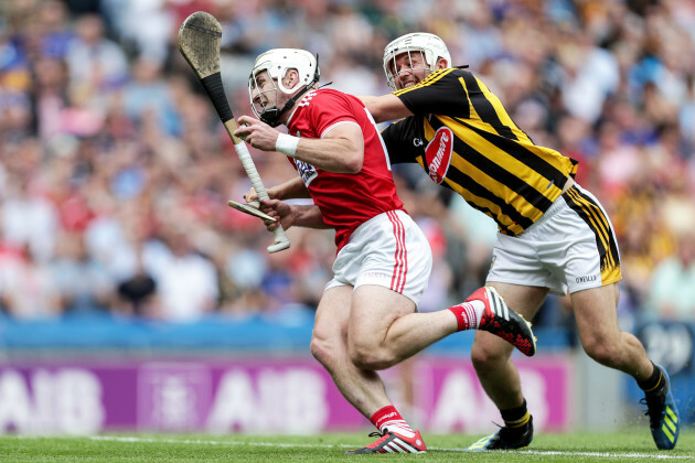 Pat Horgan on his way to scoring a goal despite Padraig Walsh