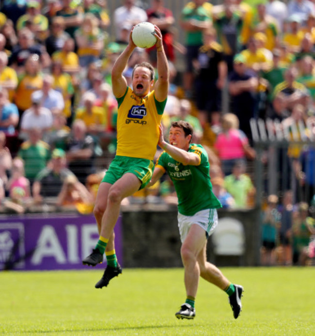 Padraic Harnan tackles Michael Murphy