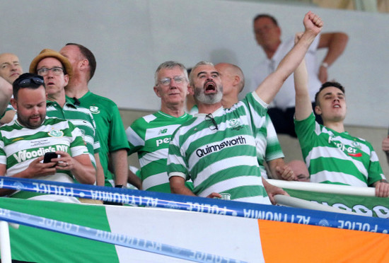 A Shamrock Rovers fan cheers on the team