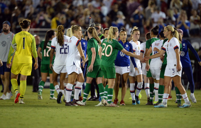 The two teams shake hands after the game