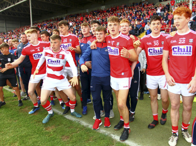 Cork players and substitutes wait for the final whistle during the dying seconds of the game