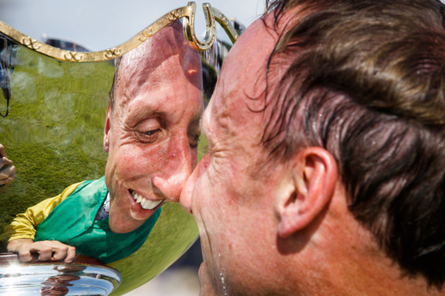 Robbie Power celebrates winning with the trophy