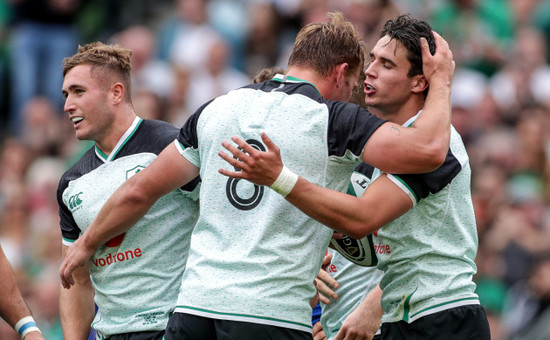 Joey Carbery celebrates scoring a try with Jordan Larmour and Jordi Murphy