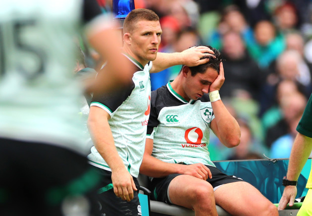Andrew Conway checks on an injured Joey Carbery