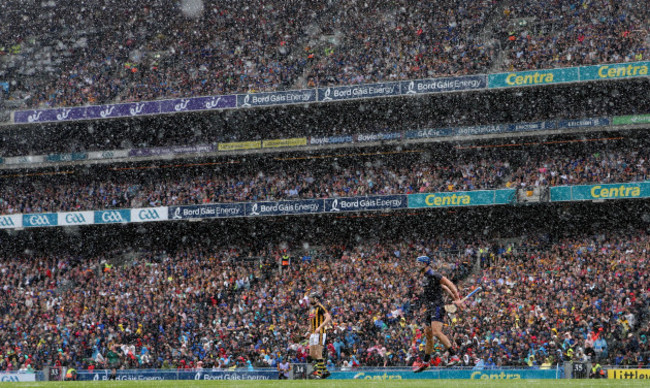 Brian Hogan encourages his team during a heavy rain shower