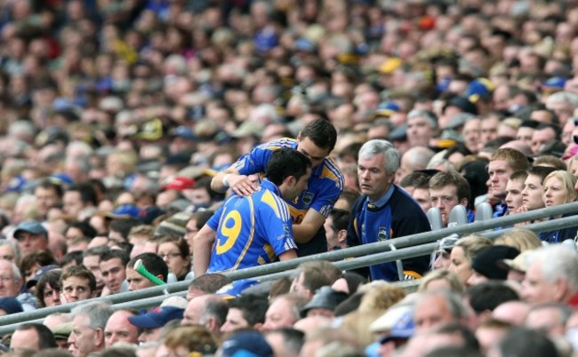 Benny Dunne is met by non playing captain Willie Ryan after being sent off