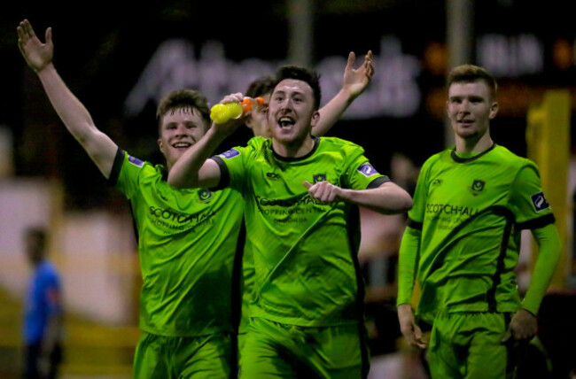 sean-brennan-celebrates-scoring-a-goal-with-a-bottle-thrown-onto-the-pitch