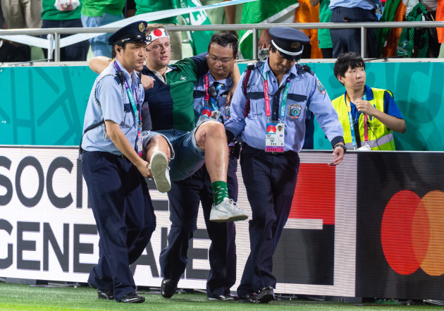 an-irish-fan-is-escorted-from-the-pitch