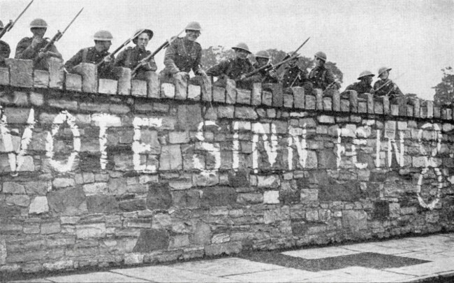 british-troops-guarding-a-wall-which-is-plastered-with-a-sinn-fein-advertisement-during-the-irish-war-of-independence-aka-anglo-irish-war-in-1920-from-twenty-five-yearspublished-1935