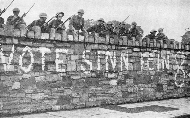 british-troops-guarding-a-wall-which-is-plastered-with-a-sinn-fein-advertisement-during-the-irish-war-of-independence-aka-anglo-irish-war-in-1920-from-twenty-five-yearspublished-1935