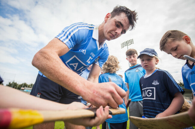 danny-sutcliffe-signs-a-young-fans-hurley-after-the-game