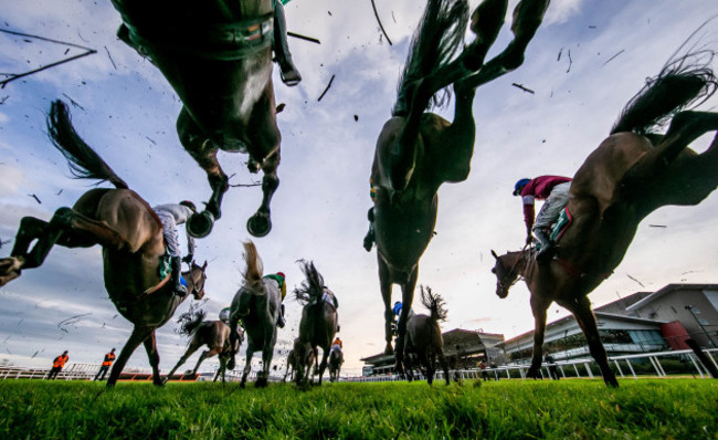 a-general-view-of-the-runners-and-riders-as-they-clear-a-fence-in-the-paddy-power-steeplechase