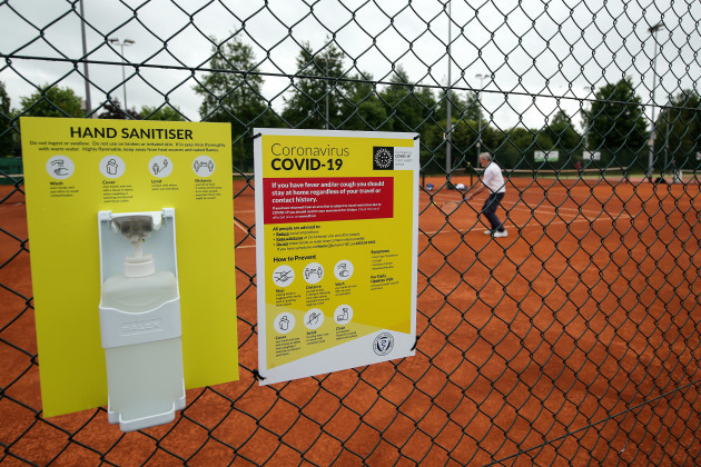 a-view-of-hand-sanitiser-in-place-as-members-of-the-public-play-tennis