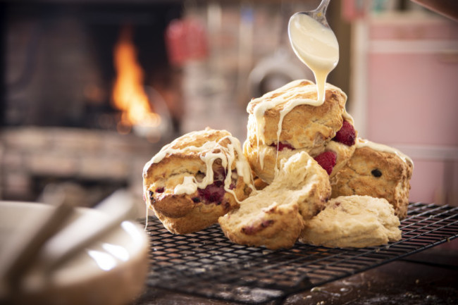 Drizzling white choc on rasp scones