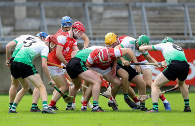 lucan-sarsfields-and-cuala-players-struggle-to-win-a-loose-ball