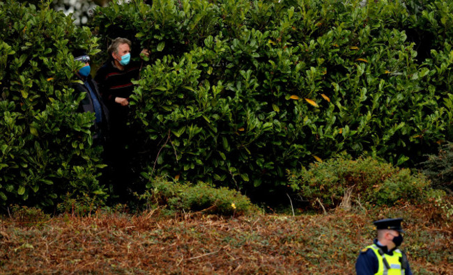 local-spectators-look-on-in-between-the-bushes