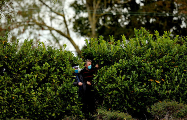 local-spectators-look-on-in-between-the-bushes