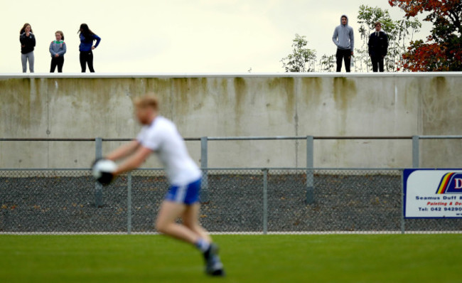 local-spectators-look-on-from-outside-the-ground