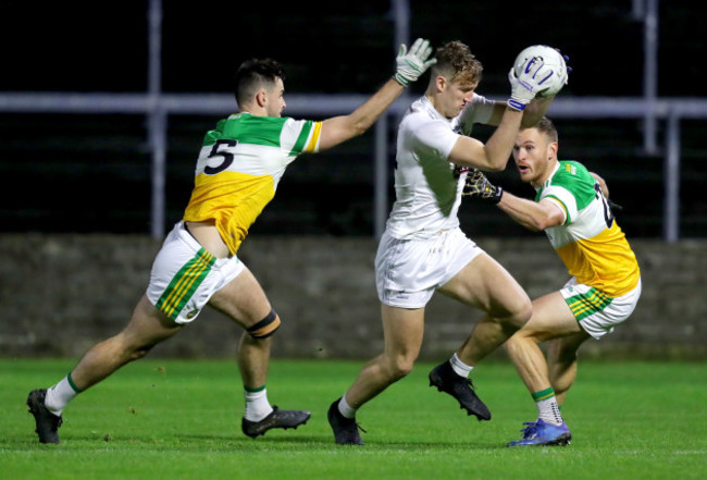 darragh-kirwan-is-tackled-by-eoin-carroll-and-declan-hogan