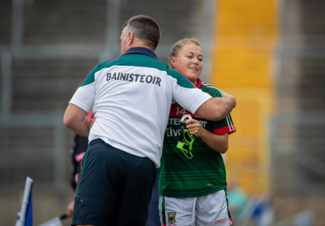 peter-leahy-hugs-sarah-rowe-as-she-comes-off-the-pitch