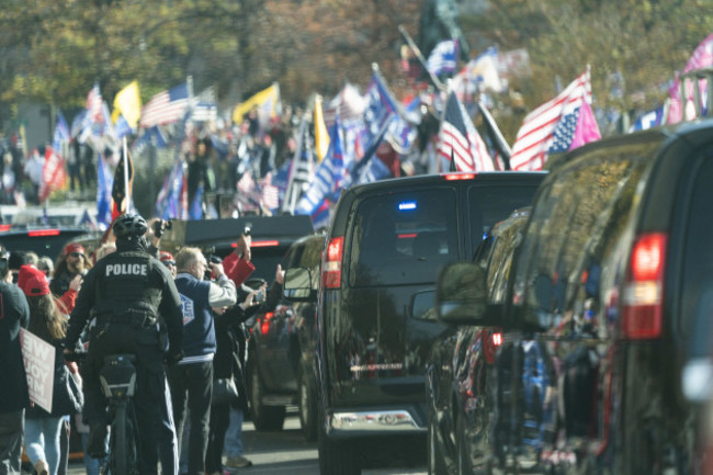 the-motorcade-carrying-u-s-president-donald-j-trump-drives-through-a-rally-of-trump-supporters