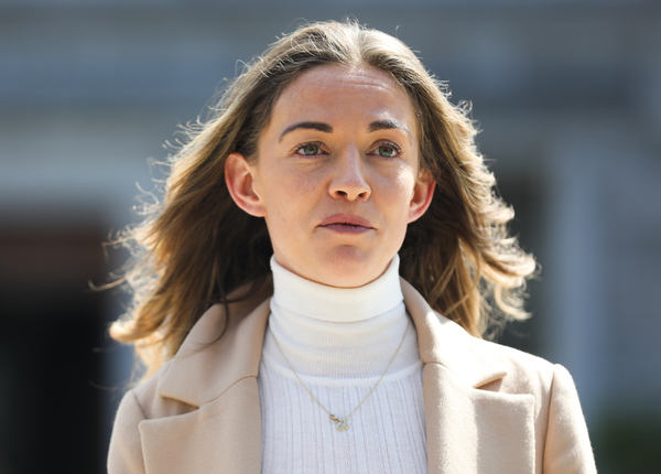 Closeup of TD Holly Cairns wearing a white polo neck and cream jacket. 