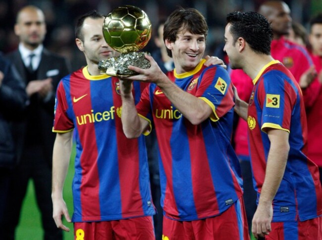 barcelonas-coach-pep-guardiola-l-watches-lionel-messi-c-holding-the-ballon-dor-trophy-with-andres-iniesta-and-xavi-hernandez-r-before-their-spanish-kings-cup-soccer-match-in-barcelona-january