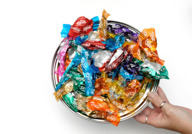 a-tin-lid-of-empty-sweet-wrappers-roses-chocolates