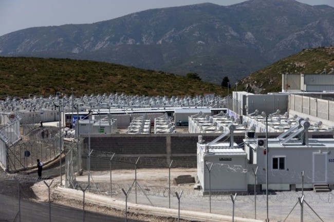 a-private-security-employee-stands-guard-inside-a-newly-inaugurated-closed-type-migrant-camp-on-the-island-of-samos-greece-september-18-2021-reutersalkis-konstantinidis