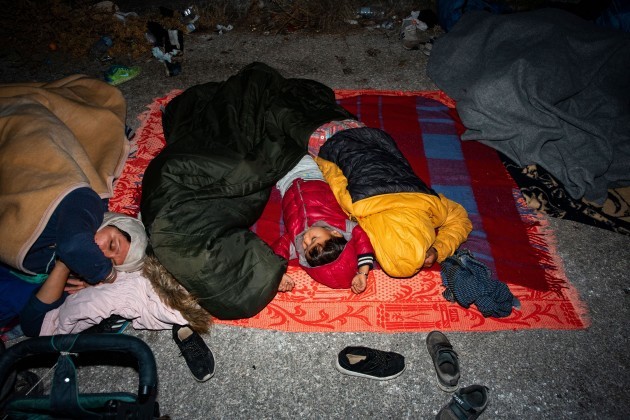 young-children-are-seen-asleep-on-the-roadside-on-the-greek-island-of-lesbos-following-a-moria-fire-more-than-13000-asylum-seekers-flee-fire-at-greeces-largest-migrant-moira-camp-at-lesbos-they-ha