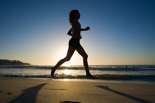 woman-jogging-along-bondi-beach-at-dawn-sydney-new-south-wales-australia