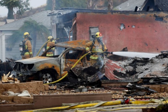 santee-ca-usa-11th-oct-2021-santee-ca-october-11-firefighters-put-out-hot-spots-at-the-scene-of-a-fatal-plane-crash-on-monday-oct-11-2021-in-santee-ca-a-small-plane-crashed-into-a-ups-tr