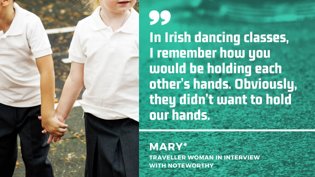 Two children in uniforms holding hands in the school yard with quote from Mary (pseudonym) - a Traveller woman in interview with Noteworthy:  In Irish dancing classes,  I remember how you would be holding each other’s hands. Obviously, they didn’t want to hold our hands.