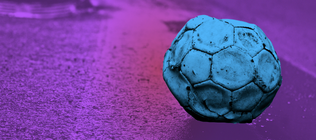 Design for Tough Start project - An old football that has too little air in it sitting on the side of the road.