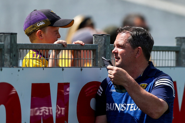 davy-fitzgerald-signs-a-young-fans-match-day-program-before-the-game