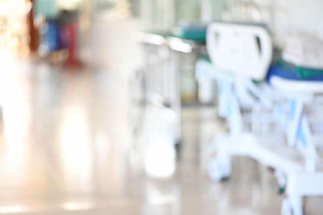 abstract-blurred-hospital-corridor-path-way-with-empty-patient-bed-for-background