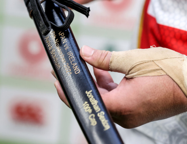 pieter-labuschagne-presents-johnny-sexton-with-a-ceremonial-sword-after-winning-his-100th-cap-for-ireland