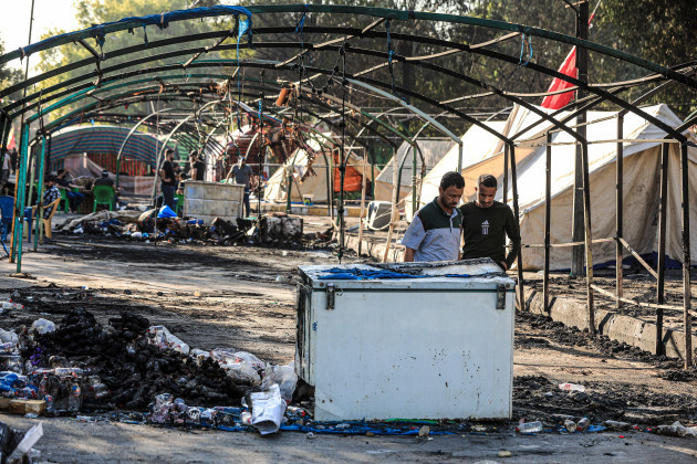 baghdad-iraq-06th-nov-2021-people-inspect-burned-out-tents-outside-baghdads-green-zone-following-the-clashes-between-anti-riot-police-and-supporters-of-pro-iran-shiite-militias-who-had-camped-out