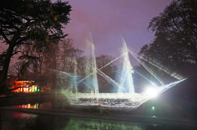 cologne-germany-16th-nov-2021-the-silhouette-of-a-ship-is-projected-onto-a-water-fountain-above-a-pond-illuminated-objects-light-projections-and-illuminated-enclosures-can-be-seen-as-part-of-the