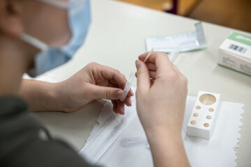 kranj-slovenia-17th-nov-2021-a-student-self-tests-with-a-rapid-covid-19-antigen-self-test-kit-in-a-primary-school-in-kranj-starting-on-wednesday-primary-and-secondary-school-children-in-slovenia